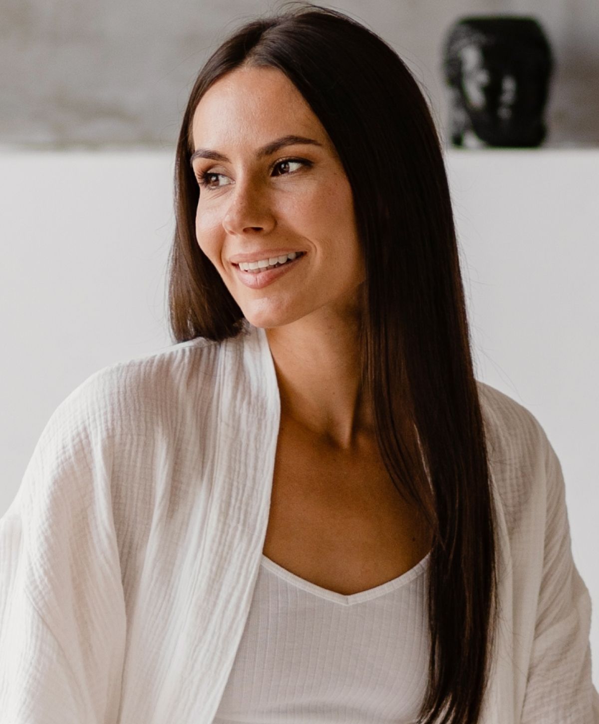 Smiling woman in relaxed home interior setting.