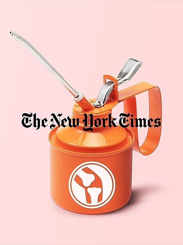 Orange oil canister on a pink background.