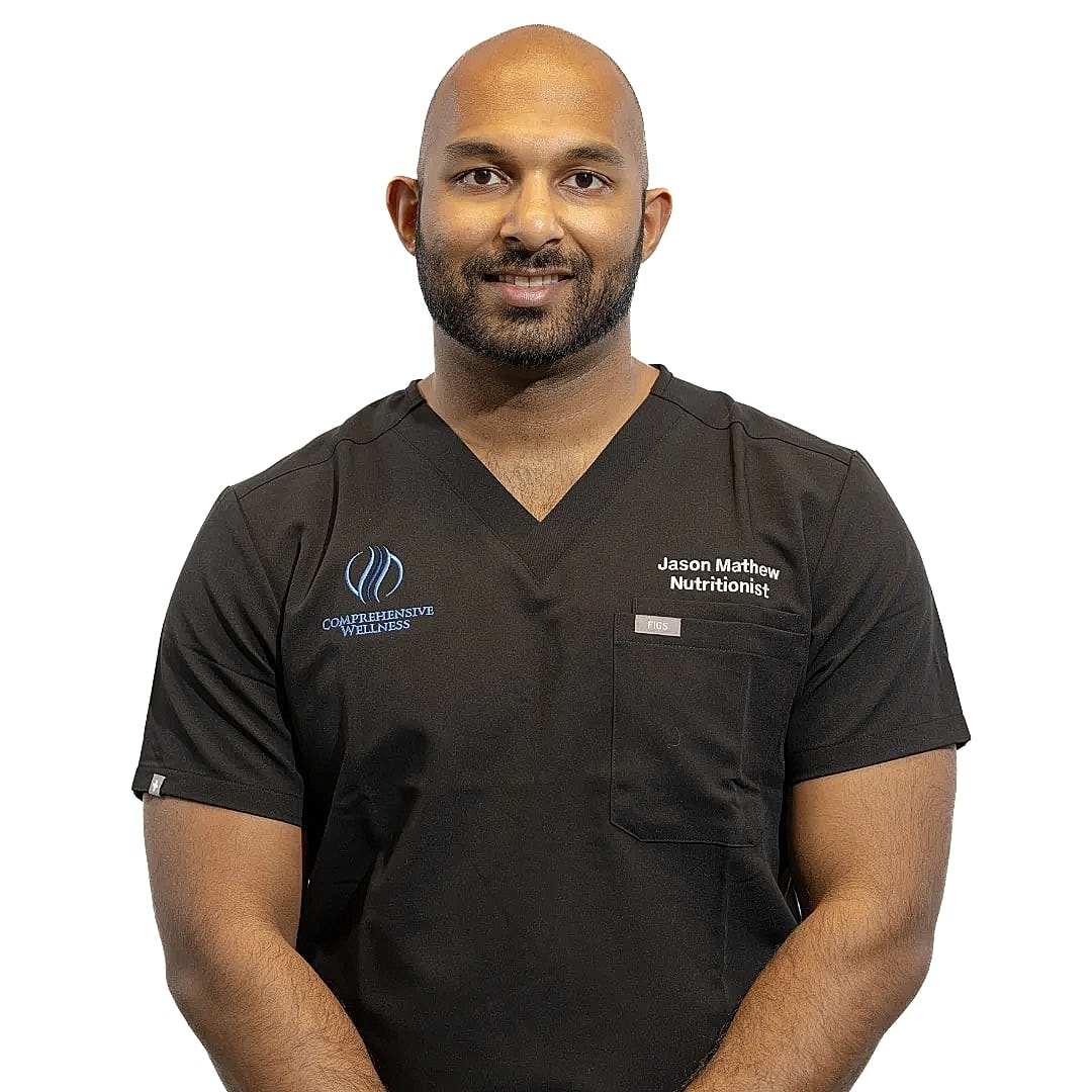Nutritionist wearing black scrubs, smiling confidently.
