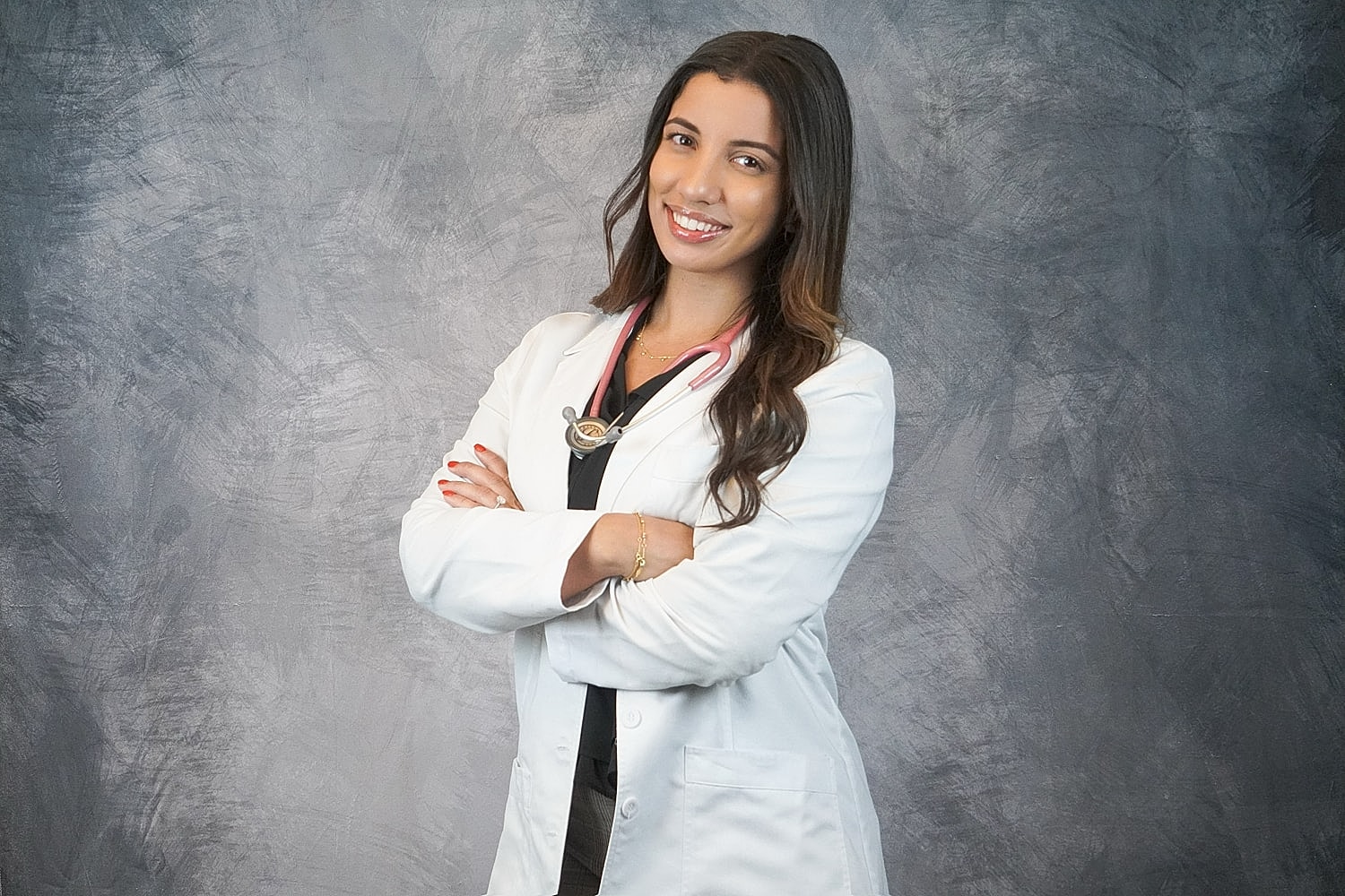 Smiling doctor in white coat with stethoscope.
