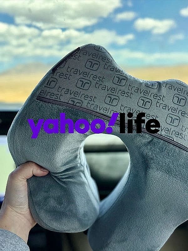 Travel pillow held in a car interior.