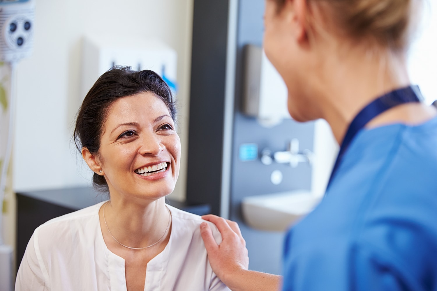 Smiling patient interacting with healthcare professional.