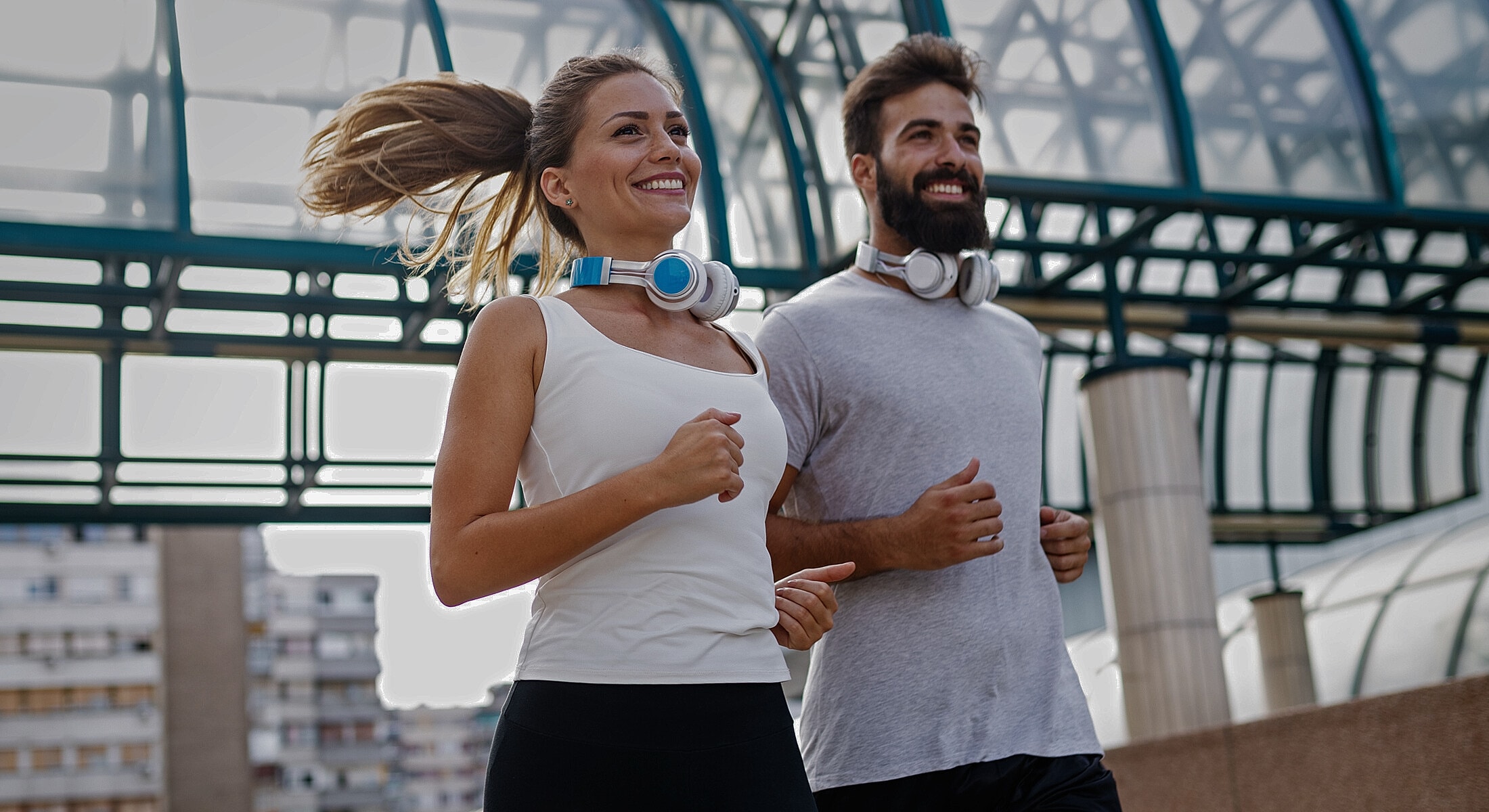 Doctor standing by office entrance, smiling confidently.
