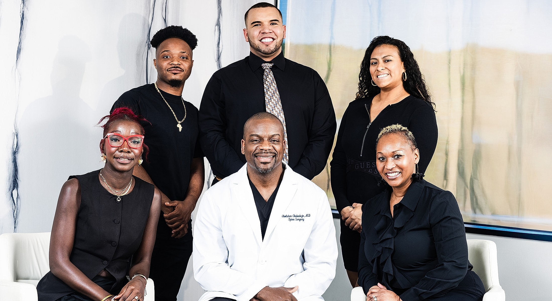 Medical team posing together in professional setting.